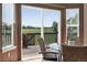 Dining area with a glass table, wicker chairs, and view of outdoor deck at 3543 Foxridge Trl, Highlands Ranch, CO 80126