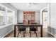 Bright dining room with a large window, wood table, chairs, and built-in cabinet at 3543 Foxridge Trl, Highlands Ranch, CO 80126