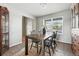 Open dining area featuring tile floors, built-in cabinet, large window, table and chairs at 3543 Foxridge Trl, Highlands Ranch, CO 80126