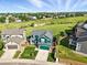 Aerial view of a two-story home with a well-manicured lawn and lush green surroundings at 3543 Foxridge Trl, Highlands Ranch, CO 80126