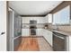 Bright kitchen featuring white cabinets, stainless steel appliances, and granite countertops at 3543 Foxridge Trl, Highlands Ranch, CO 80126