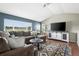 Spacious living room with a large window, sectional sofa, and an entertainment center at 3543 Foxridge Trl, Highlands Ranch, CO 80126