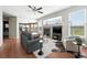 A living room with hardwood floors, a fireplace, and large windows that fill the space with natural light at 3543 Foxridge Trl, Highlands Ranch, CO 80126