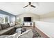 Living room boasts vaulted ceilings, a ceiling fan, sectional sofa, and an entertainment center at 3543 Foxridge Trl, Highlands Ranch, CO 80126
