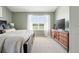 Comfortable main bedroom with a dresser, a large window, and neutral decor at 3543 Foxridge Trl, Highlands Ranch, CO 80126