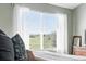 Bright main bedroom showcases a dresser, a large window with views, and plush bedding at 3543 Foxridge Trl, Highlands Ranch, CO 80126
