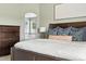 The main bedroom has a wood bed frame, coordinated throw pillows and a turtle print in the bathroom mirror at 3543 Foxridge Trl, Highlands Ranch, CO 80126