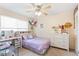 This bedroom features a ceiling fan, a window with blinds and an adjacent dresser at 5300 E Cherry Creek South Dr # 124, Denver, CO 80246