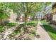 Well-maintained common area with walkways, mature trees, and inviting outdoor seating at 5300 E Cherry Creek South Dr # 124, Denver, CO 80246