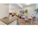 Inviting dining area with an adjacent living room, complemented by a fireplace and large windows at 5300 E Cherry Creek South Dr # 124, Denver, CO 80246