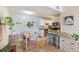 Bright dining area leading to the kitchen featuring white cabinetry and modern appliances at 5300 E Cherry Creek South Dr # 124, Denver, CO 80246