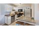 Bright kitchen features white cabinets, stainless appliances, granite counters, and convenient breakfast bar seating at 5300 E Cherry Creek South Dr # 124, Denver, CO 80246