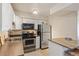Bright, tiled kitchen offers stainless appliances, breakfast bar, white cabinets, and ample counter space at 5300 E Cherry Creek South Dr # 124, Denver, CO 80246