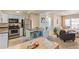 Open concept living space featuring kitchen with stainless appliances and cozy living area with balcony access at 5300 E Cherry Creek South Dr # 124, Denver, CO 80246