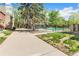 This is a pool in a community surrounded by a fence and green grass under the shade of a large tree at 5300 E Cherry Creek South Dr # 124, Denver, CO 80246