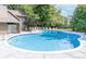 Community pool with sun loungers, blue tile trim, and well-maintained concrete perimeter under a blue sky at 5300 E Cherry Creek South Dr # 124, Denver, CO 80246