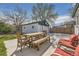 Inviting backyard patio with wooden dining set and detached garage at 1374 S Beach Ct, Denver, CO 80219