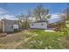 Expansive backyard with a mix of grass, garden, and garage at 1374 S Beach Ct, Denver, CO 80219
