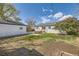 Large backyard with patio, detached garage, and blooming trees at 1374 S Beach Ct, Denver, CO 80219