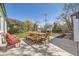 Spacious backyard patio with table, bench, chairs, and colorful garden at 1374 S Beach Ct, Denver, CO 80219