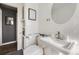 This bathroom features white subway tile, black accents, and updated fixtures at 1374 S Beach Ct, Denver, CO 80219