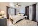 This primary bedroom offers great natural light, modern decor, and a ceiling fan at 1374 S Beach Ct, Denver, CO 80219