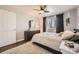 Bedroom with hardwood floors, ceiling fan, textured rug and view of white door and exterior window at 1374 S Beach Ct, Denver, CO 80219
