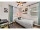 This bedroom has wood floors, natural light, and shelves with accent pieces at 1374 S Beach Ct, Denver, CO 80219