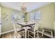 Charming dining area with a unique light fixture and bright, airy feel from large windows at 1374 S Beach Ct, Denver, CO 80219