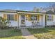Charming white brick home with a cozy front porch and natural wood accents at 1374 S Beach Ct, Denver, CO 80219