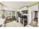 Well-equipped kitchen with a refrigerator, modern appliances, and an adjacent dining area at 1374 S Beach Ct, Denver, CO 80219