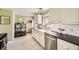 Bright kitchen with white cabinets, stainless steel appliances, and a farmhouse sink at 1374 S Beach Ct, Denver, CO 80219