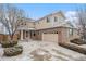 Beautiful two-story brick and siding home with an attached two-car garage and a well-maintained front yard at 24285 E Wagontrail Ave, Aurora, CO 80016