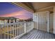 Outdoor balcony area with wooden floors, a white railing, and beautiful sunset views at 5756 N Genoa Way # 12-305, Aurora, CO 80019