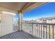 Balcony with white railing provides expansive views of the surrounding neighborhood and clear blue sky at 5756 N Genoa Way # 12-305, Aurora, CO 80019