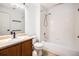 Well-lit bathroom with a vanity, sink, toilet, and combined bathtub and shower at 5756 N Genoa Way # 12-305, Aurora, CO 80019