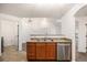 Practical kitchen with a breakfast bar and appliances, connecting to the living area at 5756 N Genoa Way # 12-305, Aurora, CO 80019