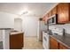 Compact kitchen area with modern appliances and easy access to living space at 5756 N Genoa Way # 12-305, Aurora, CO 80019