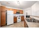 Functional kitchen layout with efficient appliances and tiled flooring at 5756 N Genoa Way # 12-305, Aurora, CO 80019