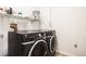Laundry room with black washer and dryer at 5756 N Genoa Way # 12-305, Aurora, CO 80019