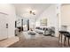 Bright living room featuring vaulted ceilings, a cozy fireplace, neutral carpet, and lots of natural light at 5756 N Genoa Way # 12-305, Aurora, CO 80019