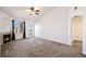 Spacious living room with neutral carpet, fireplace, and walkout to the balcony at 5756 N Genoa Way # 12-305, Aurora, CO 80019