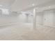 Spacious basement area with neutral carpet, recessed lighting, and support beams at 6247 S Locust St, Centennial, CO 80111