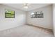 Bright bedroom featuring neutral carpet, ceiling fan, and natural light from two windows at 6247 S Locust St, Centennial, CO 80111