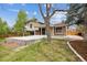 Two-story home featuring a concrete patio and outdoor area for entertaining at 6247 S Locust St, Centennial, CO 80111