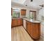 Bright eat-in kitchen featuring wooden cabinets, granite counters, a window over the sink, and access to the living area at 6247 S Locust St, Centennial, CO 80111