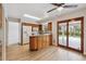 Bright kitchen with wood cabinets, granite counters, stainless fridge and appliances, and sliding doors to the patio at 6247 S Locust St, Centennial, CO 80111