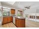 Bright eat-in kitchen featuring wooden cabinets, granite counters, a window over the sink, and access to the living area at 6247 S Locust St, Centennial, CO 80111