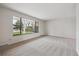 Bright living room featuring a large window with views of the exterior, neutral paint, and neutral carpeting at 6247 S Locust St, Centennial, CO 80111