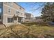 Fenced backyard with lawn, patio, and second story deck, perfect for entertaining guests at 4787 Dunkirk St, Denver, CO 80249